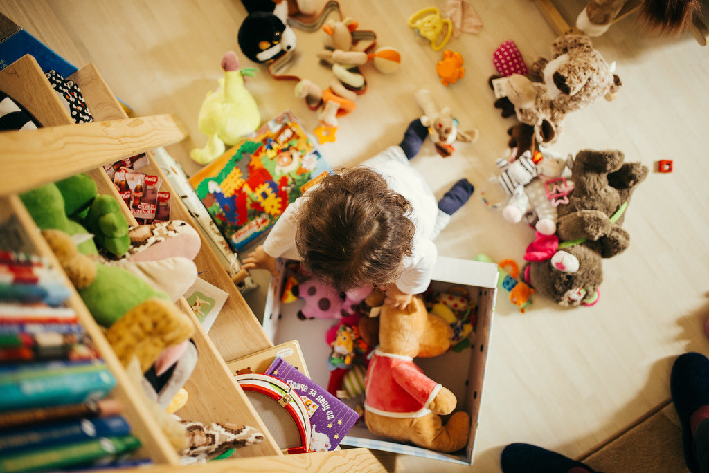 A cute little girl playing with toys at home