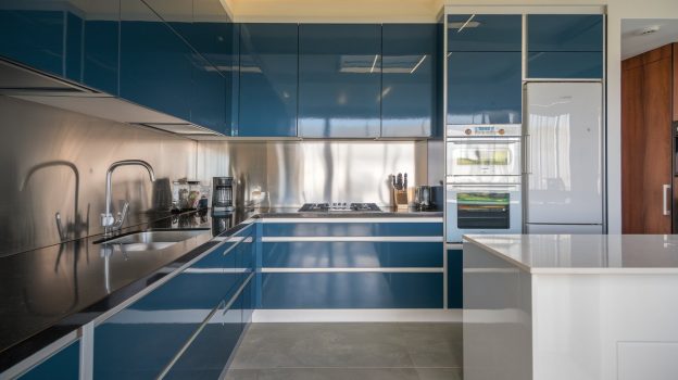 A kitchen with blue cabinets and stainless steel appliances - Steel Blue Industrial