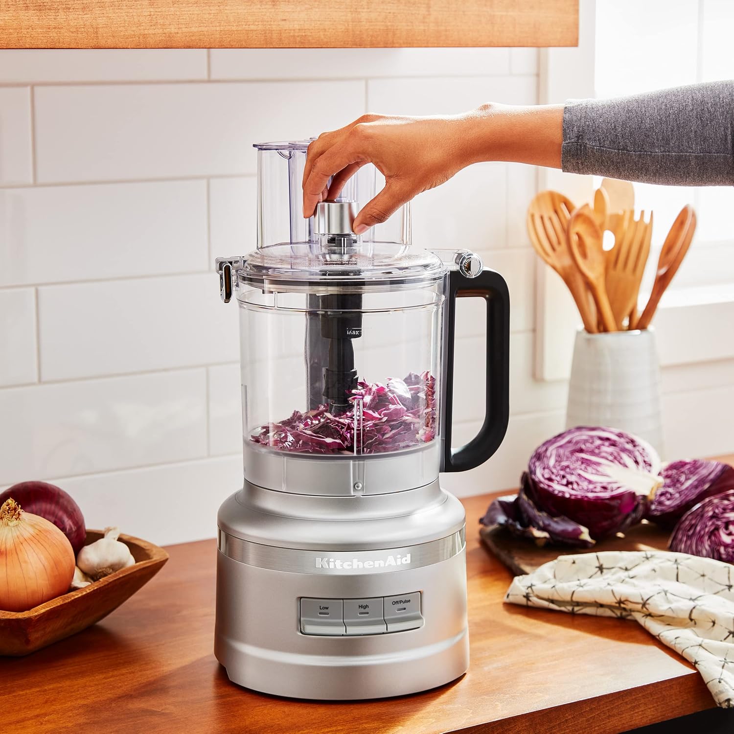 A person using a food processor  Description automatically generated