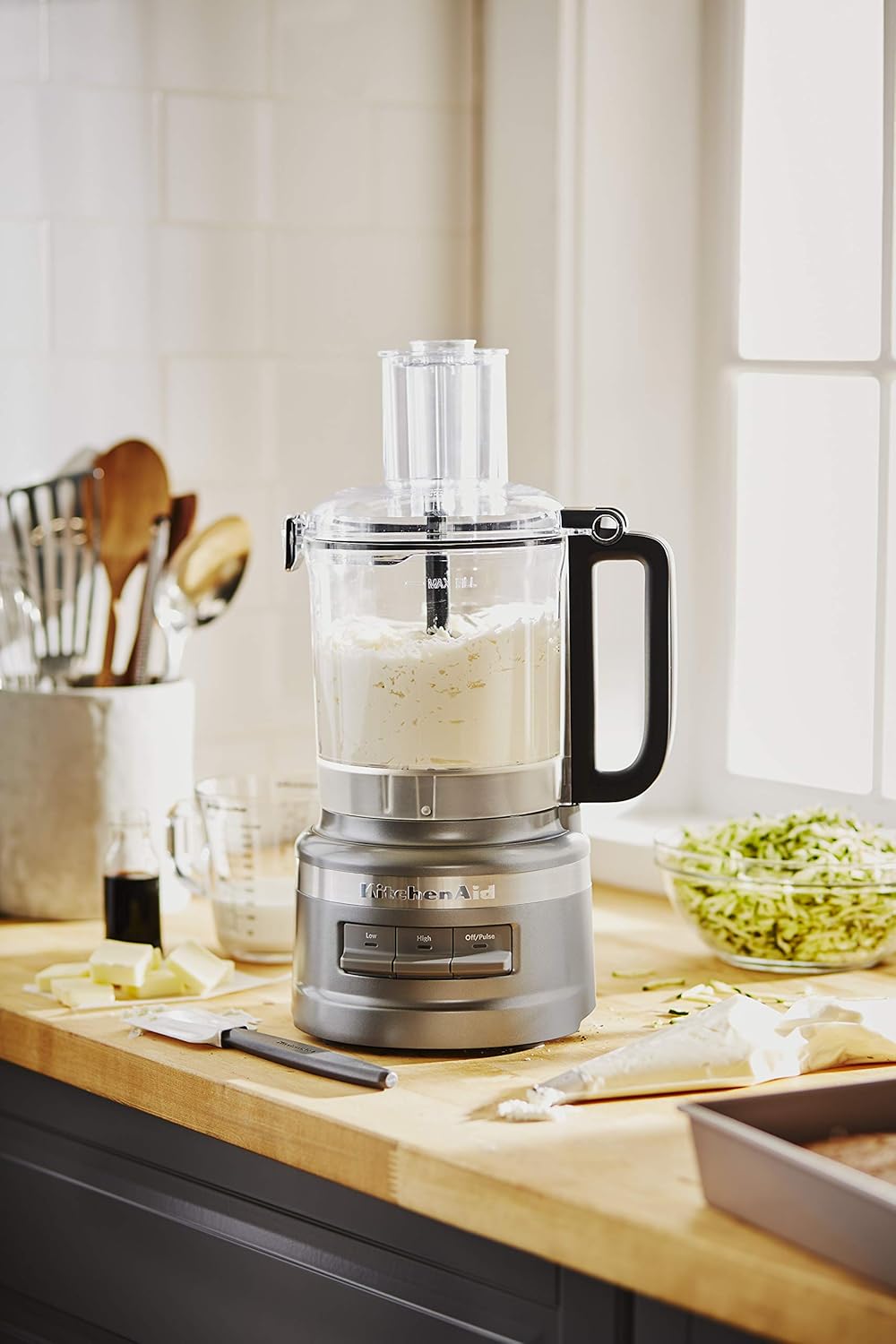 A blender with a container of food KitchenAid KFP0919CU 9 Cup Plus Food Processor