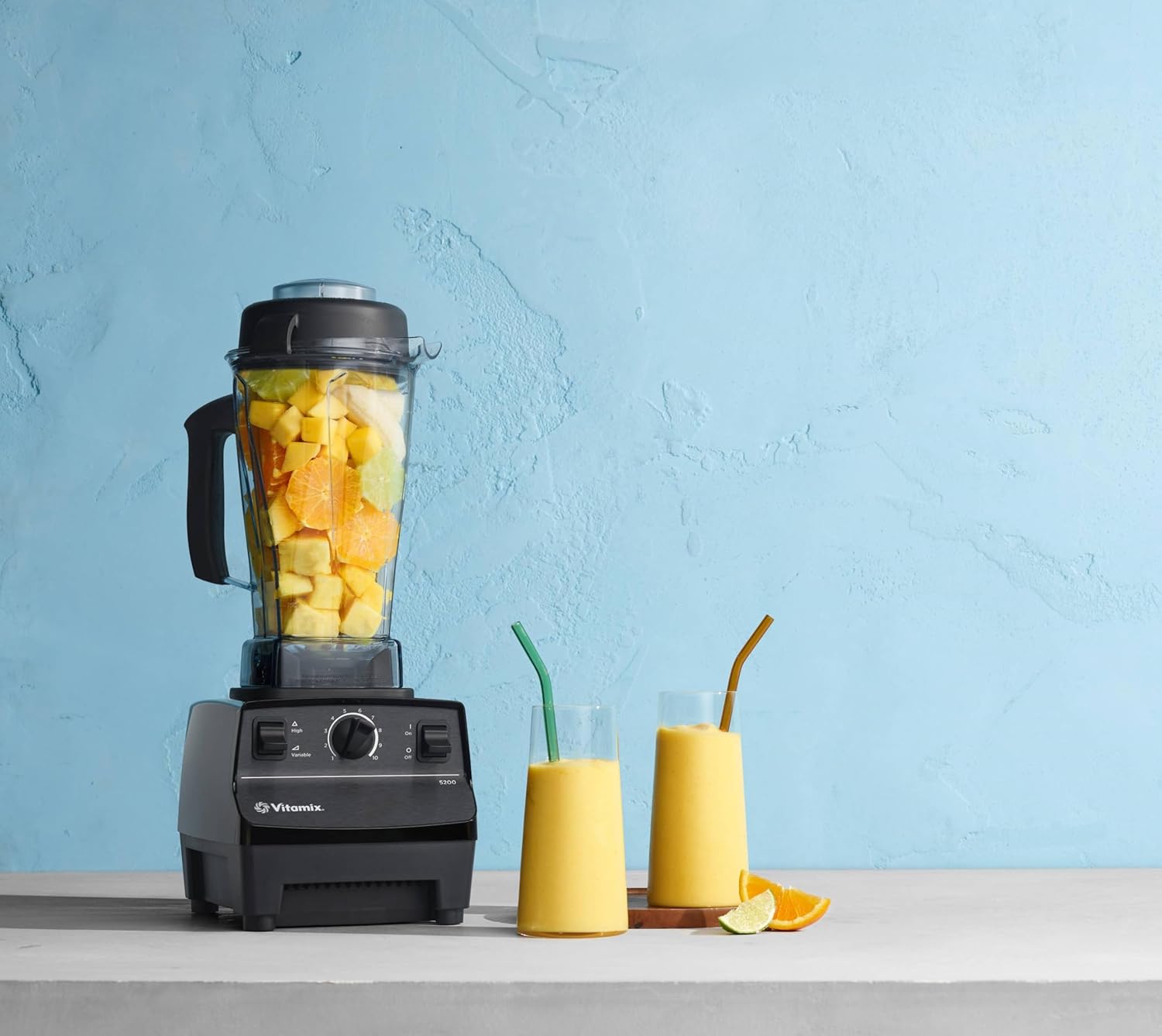 A blender with fruit in it  Description automatically generated