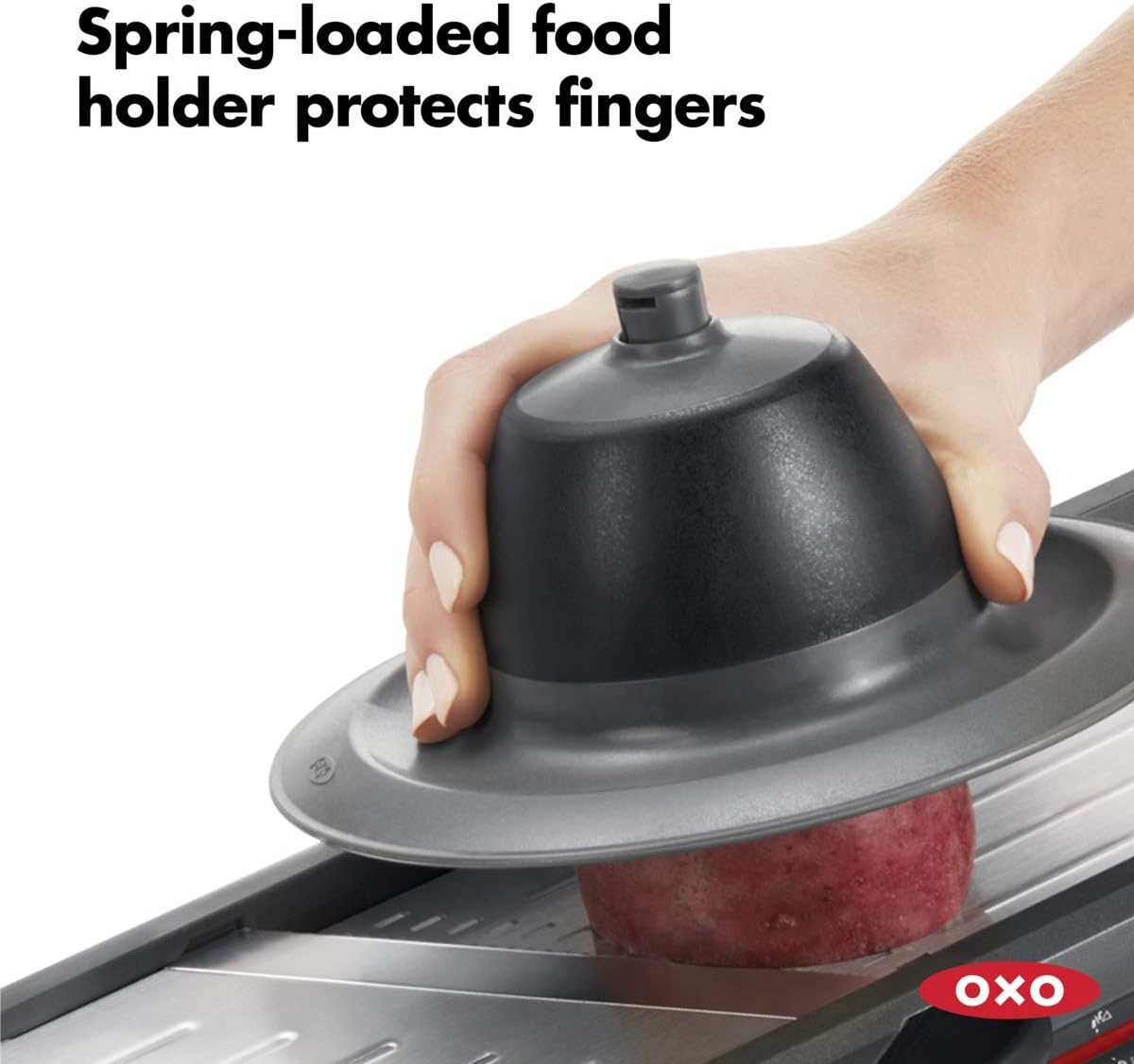 A hand holding a black container  Description automatically generated