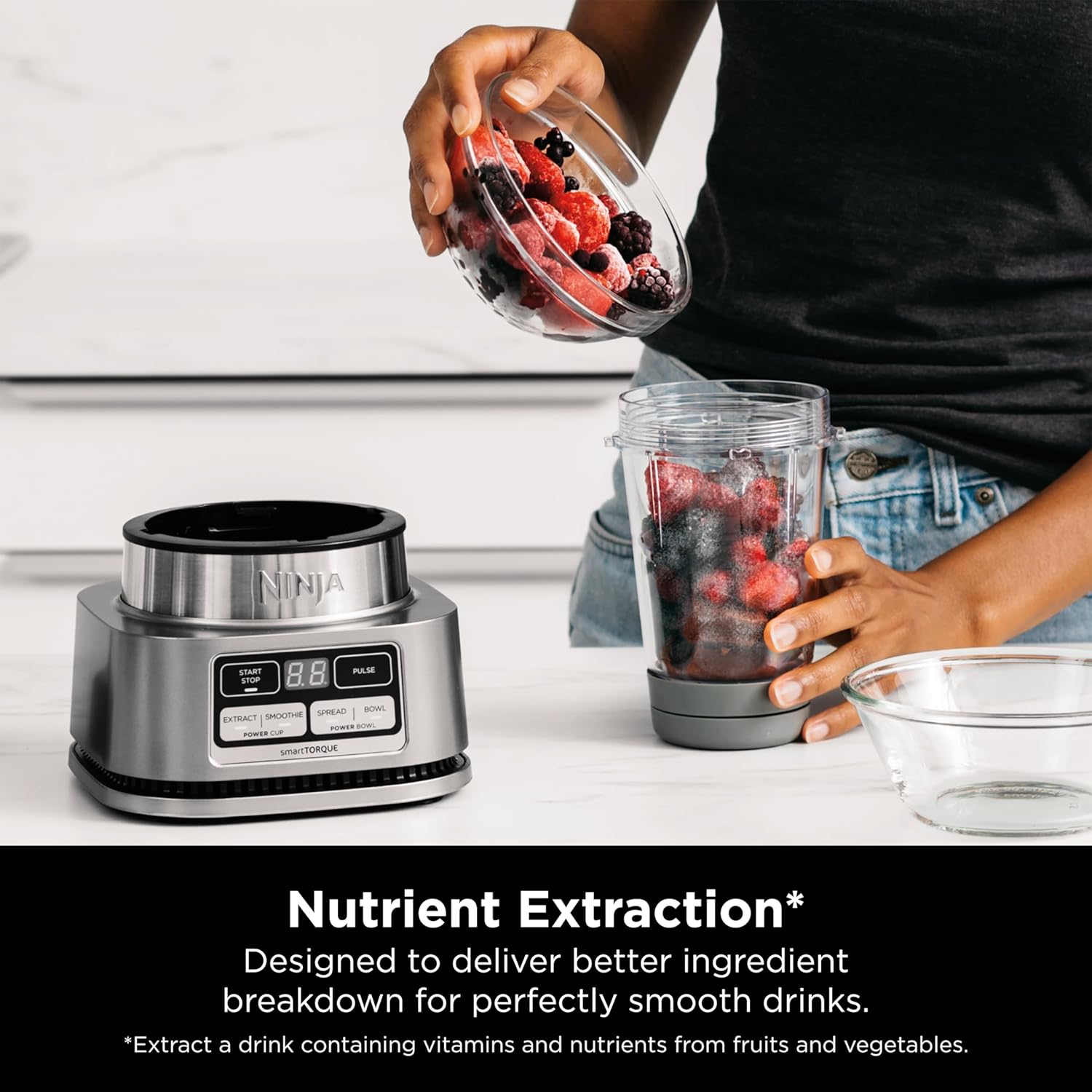 A person pouring berries into a blender  Description automatically generated