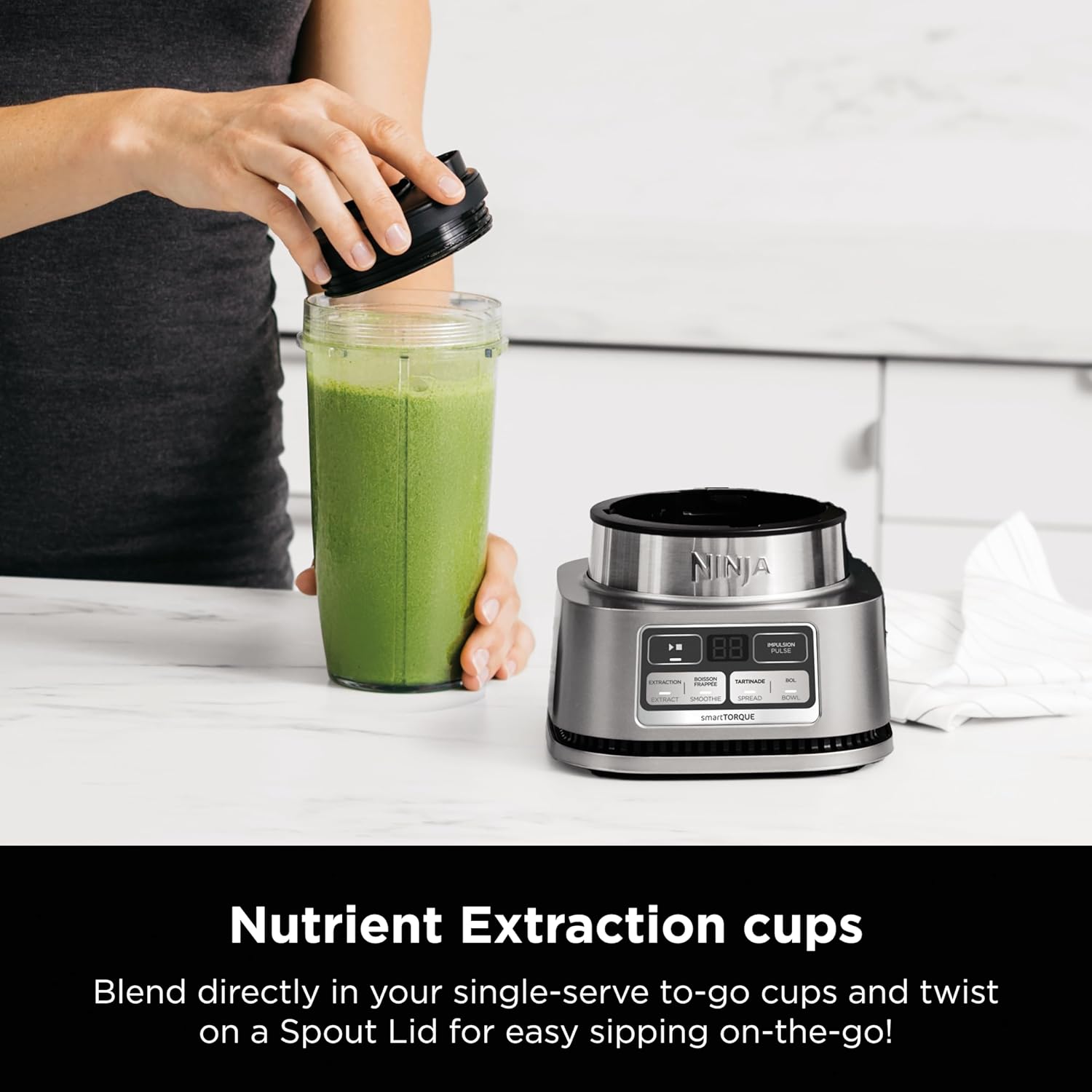 A person pouring a green drink into a blender  Description automatically generated