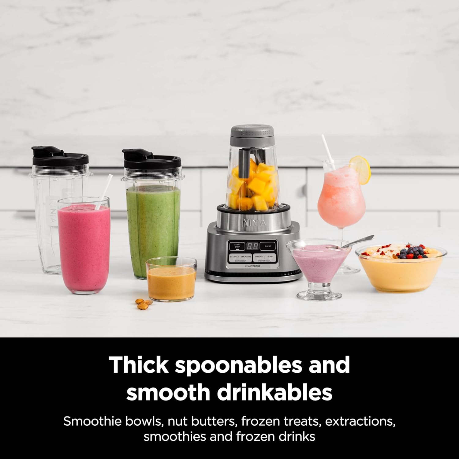 A blender with different colored drinks  Description automatically generated