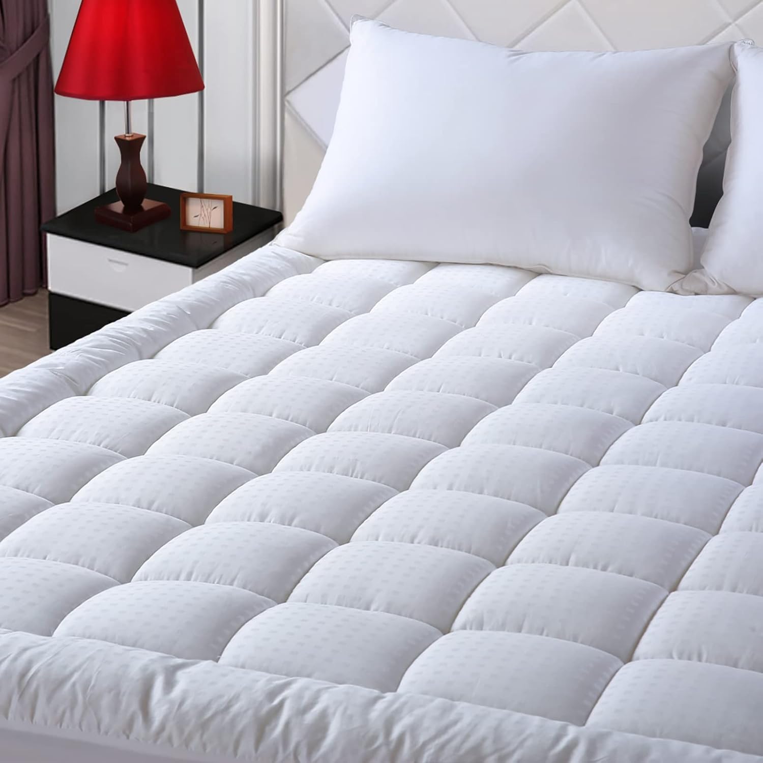 A bed with a white blanket and a red lamp  AI-generated content may be incorrect.